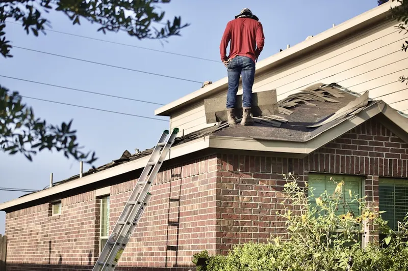 Professional roofer working on a residential roof in Rosemont North